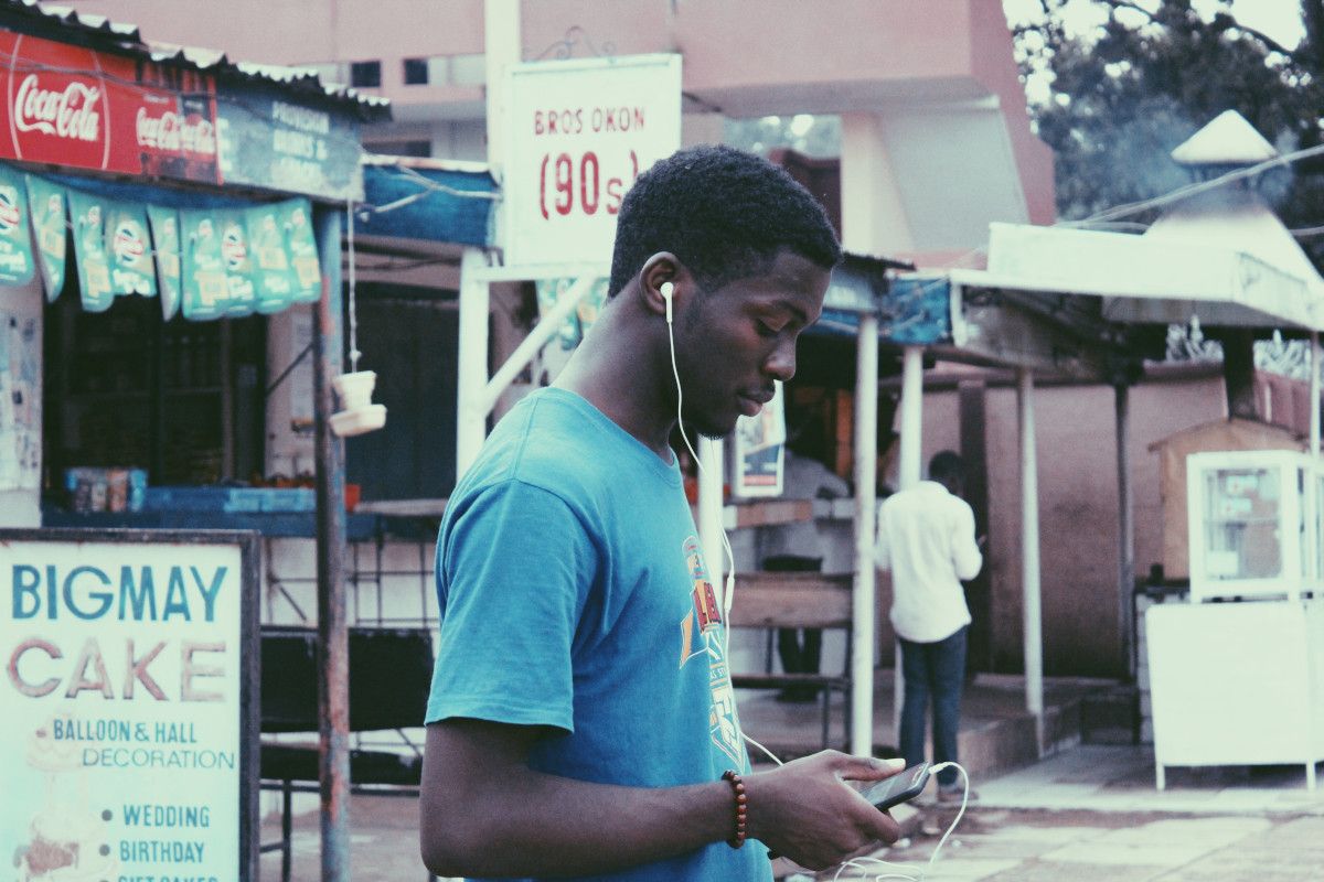 Cover photo "A teenager using his phone". Photo location, Ahmadu Bello University, Zaria, Kaduna, Nigeria.